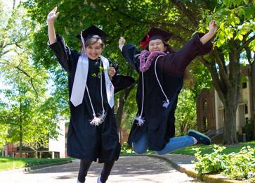 graduates jump in the air