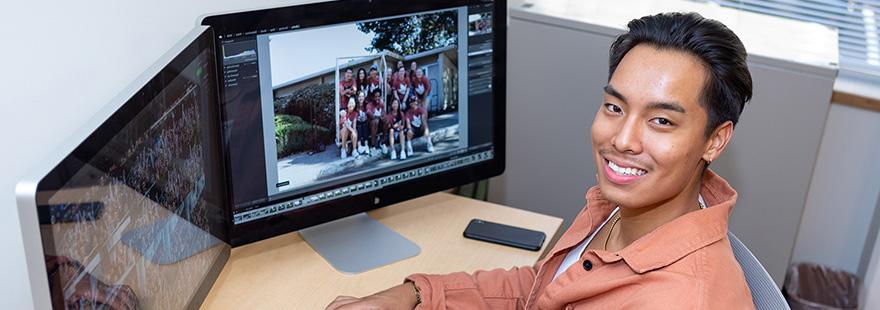 An SPU student processes photos in their on-campus job